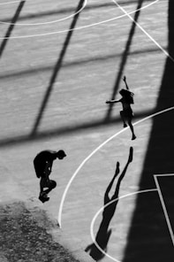 A person jumping up into the air on a basketball court