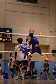 A group of young men playing a game of volleyball