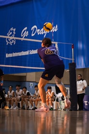 A group of men playing a game of volleyball