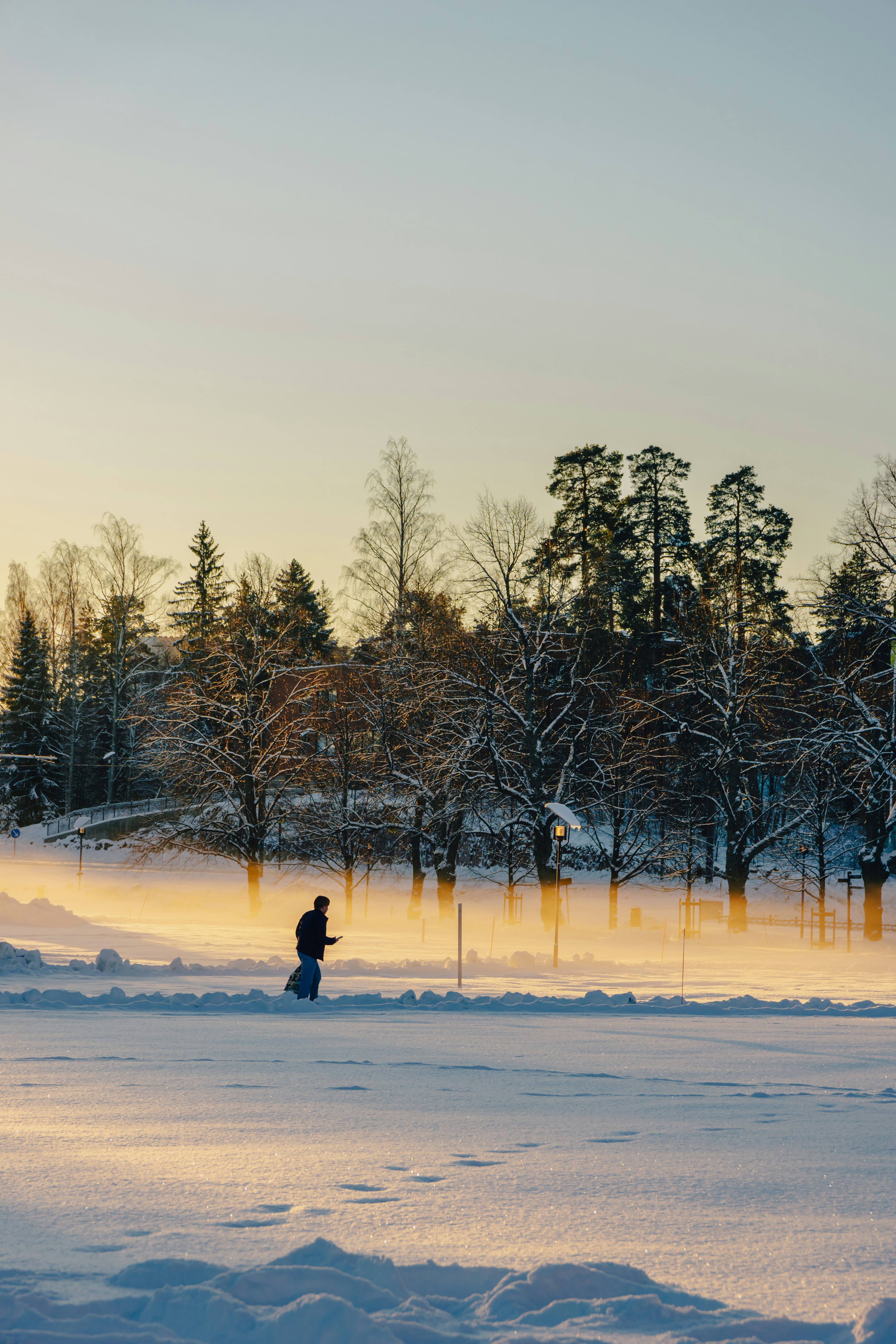 A person riding a snowboard down a snow covered slope