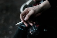 A person holding a cigarette in their hand