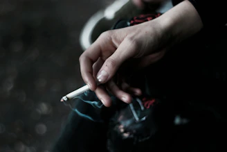 A person holding a cigarette in their hand