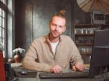 A man sitting in front of a laptop computer
