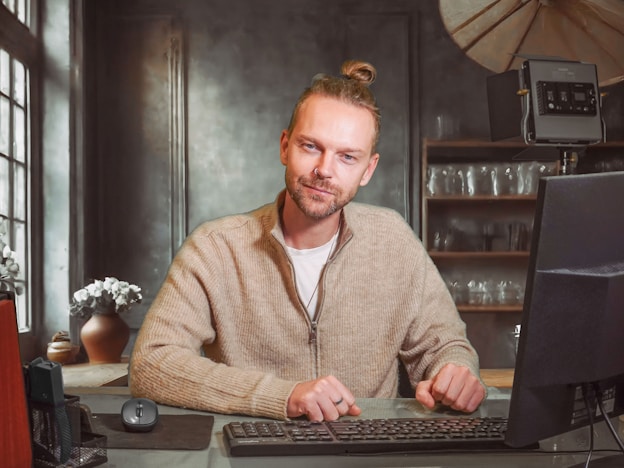 A man sitting in front of a laptop computer