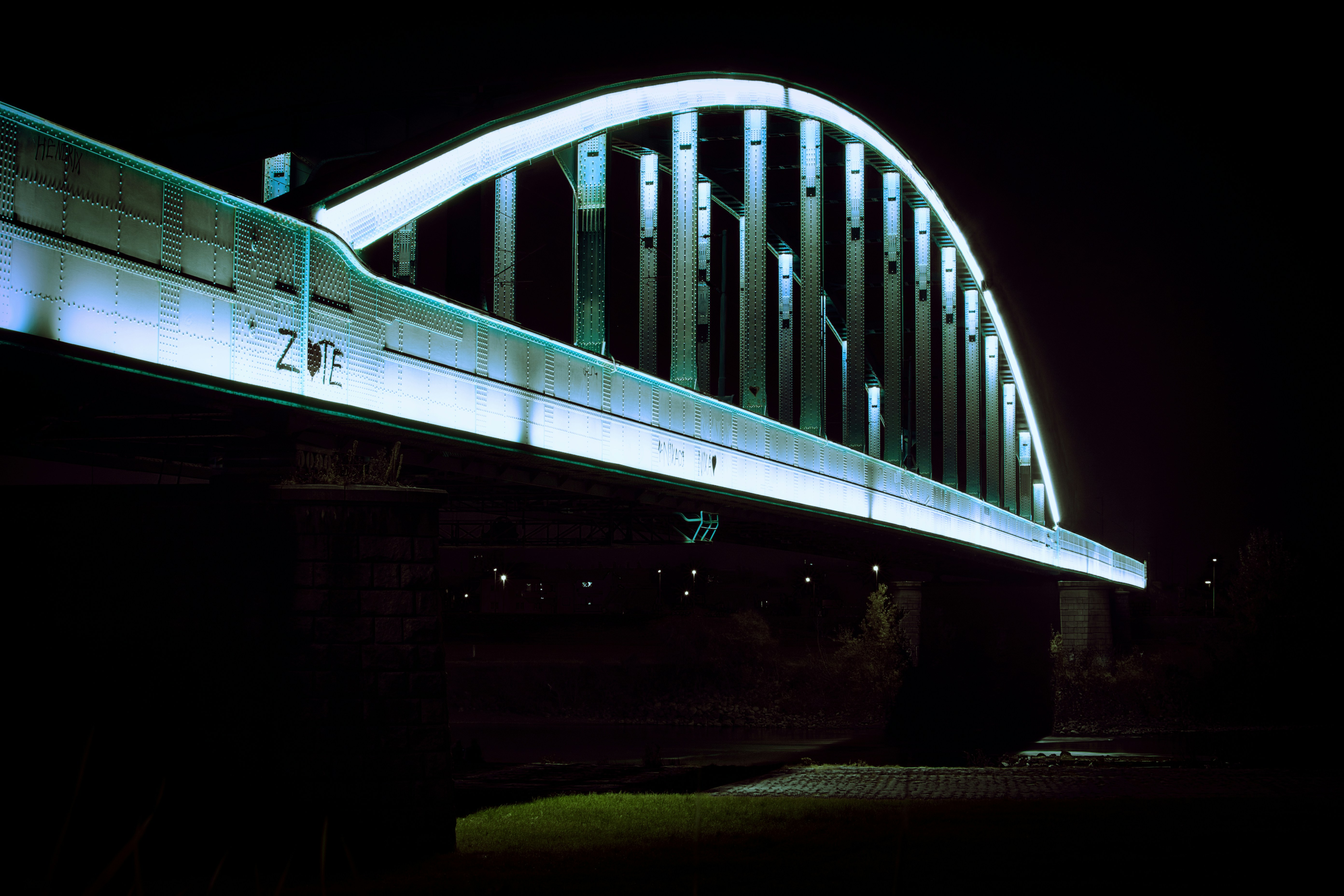 Lighted steel bridge at night