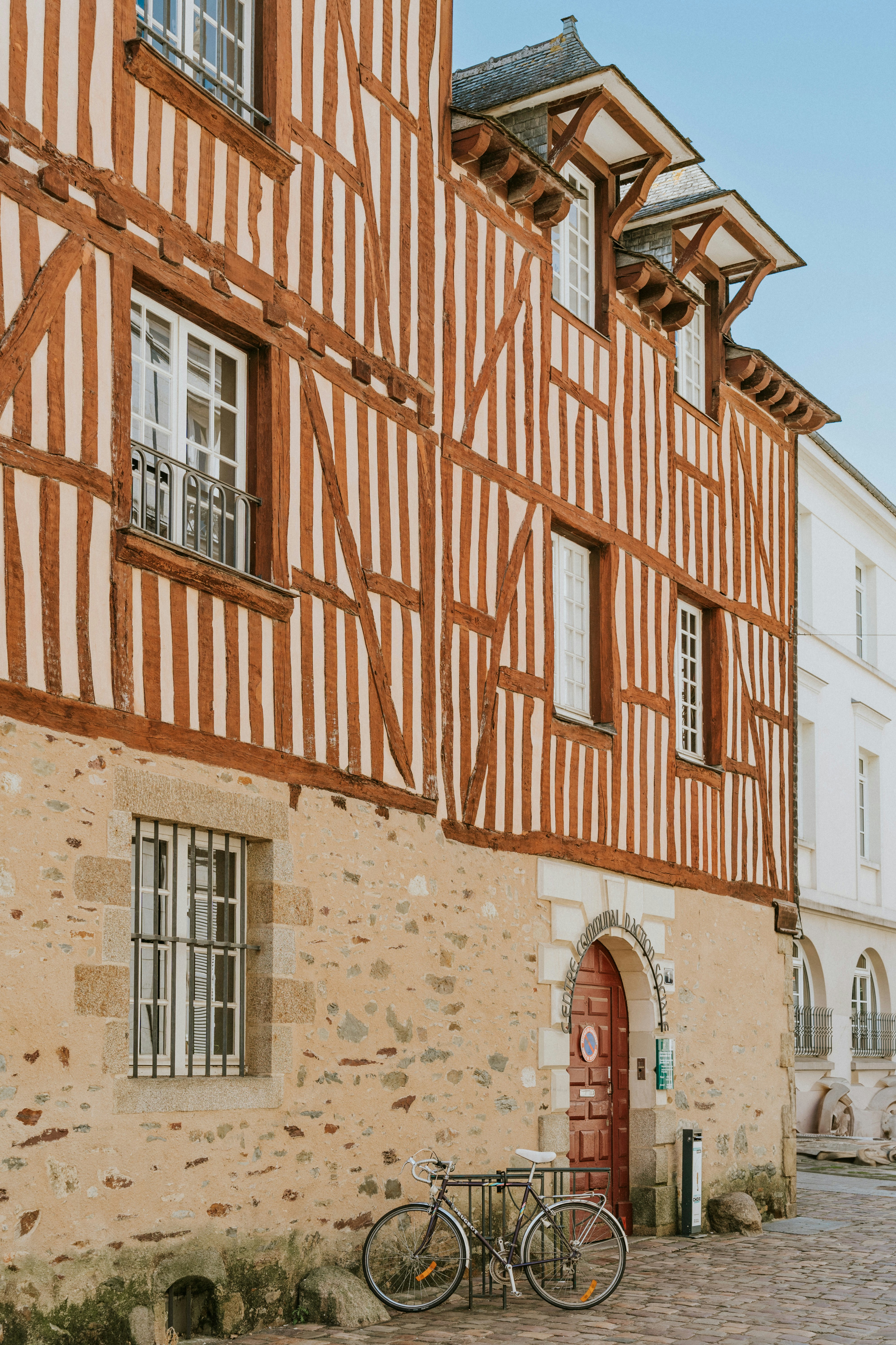 A bike is parked in front of a building