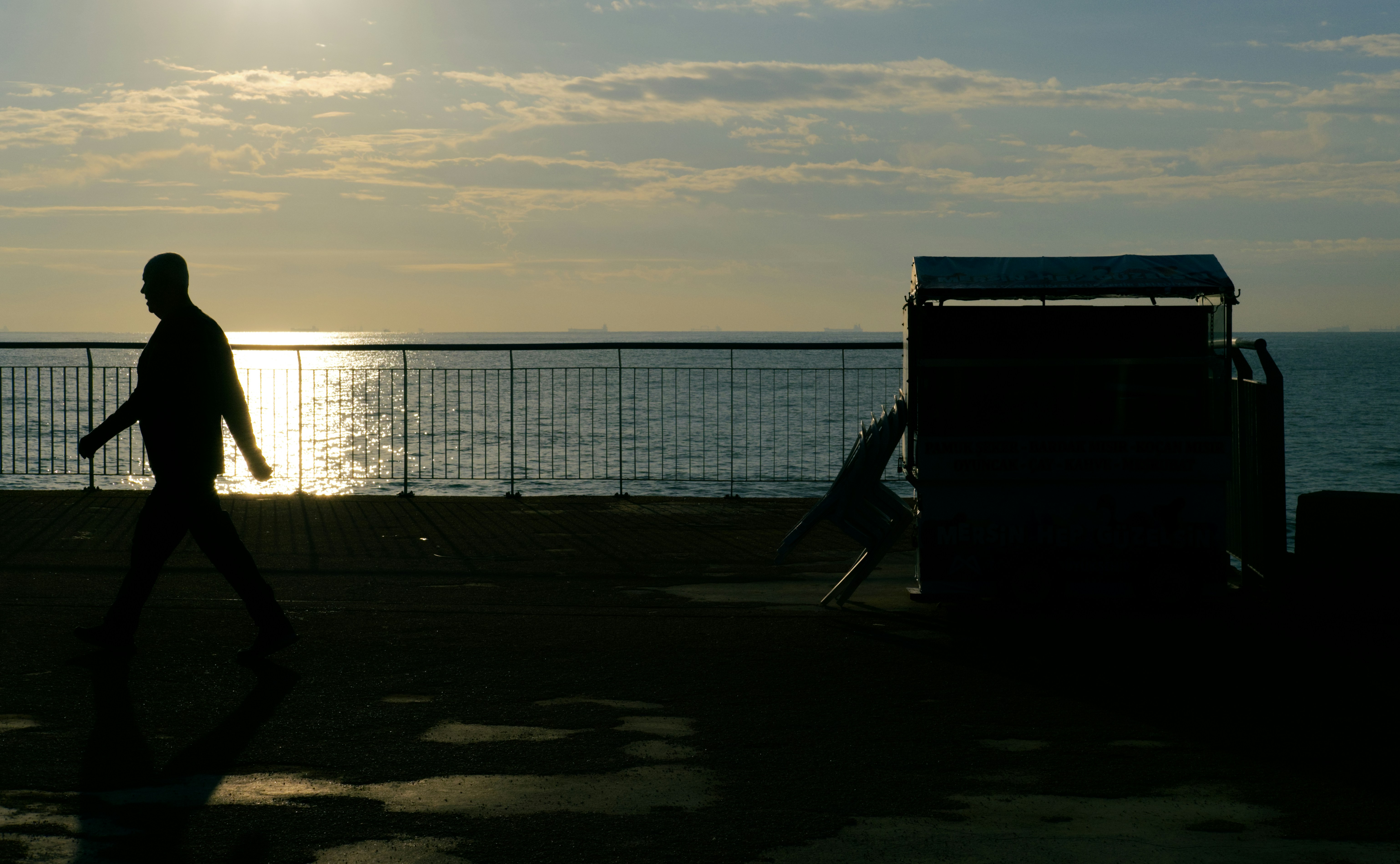 A man walking along a beach near the ocean