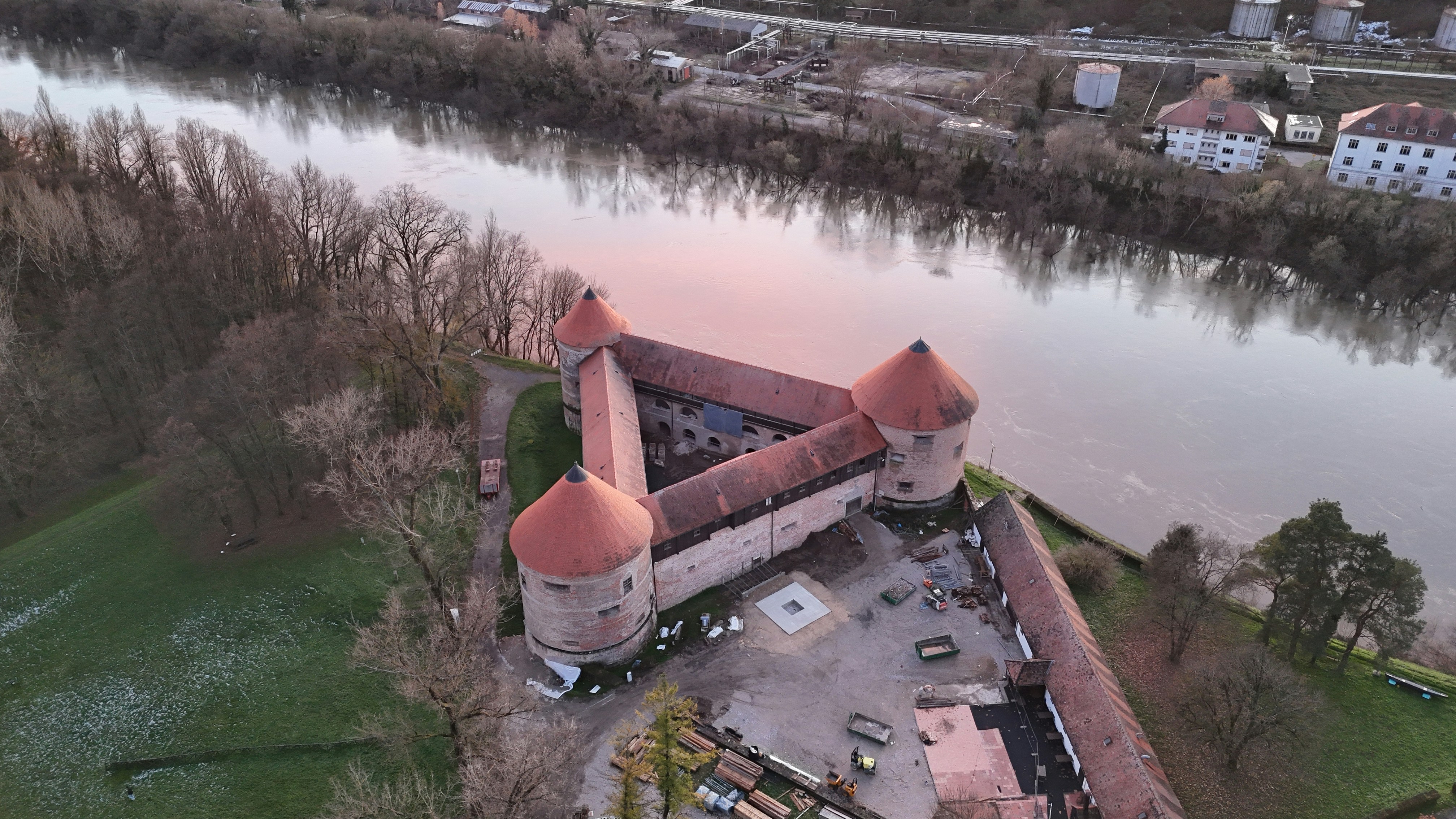 An aerial view of a building next to a river