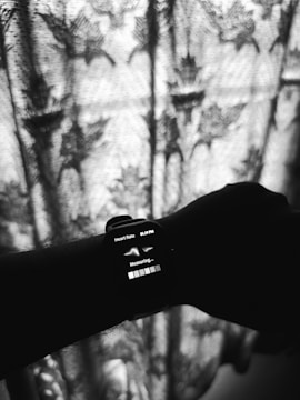 A black and white photo of a person holding a cell phone