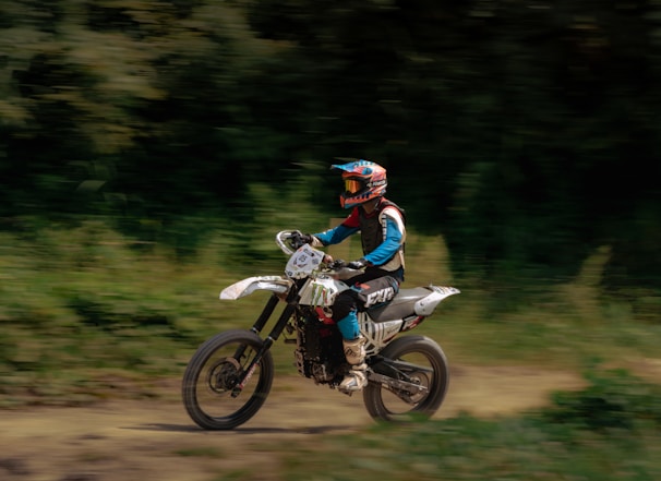 A person riding a dirt bike on a dirt road