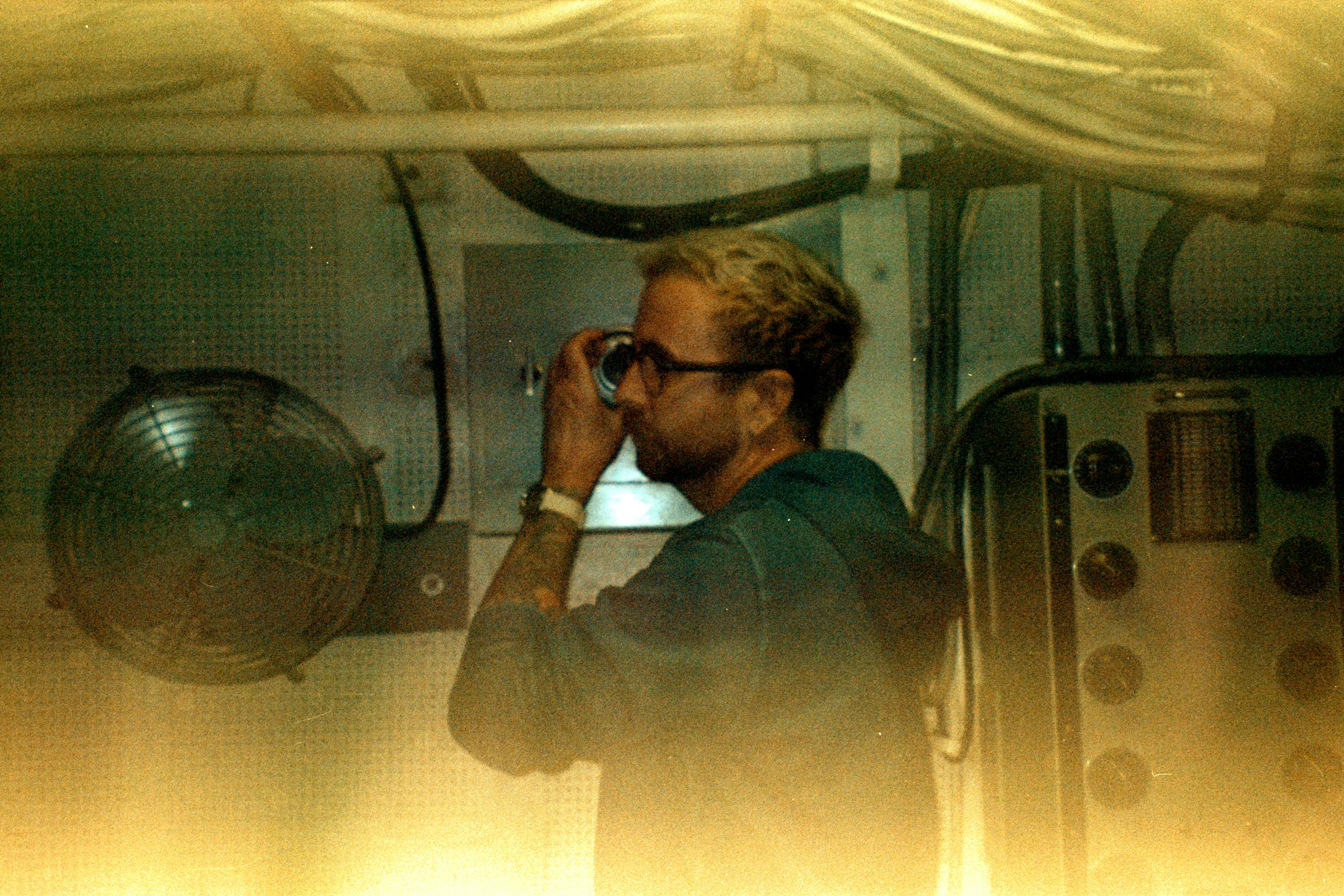 A man talking on a cell phone in a room