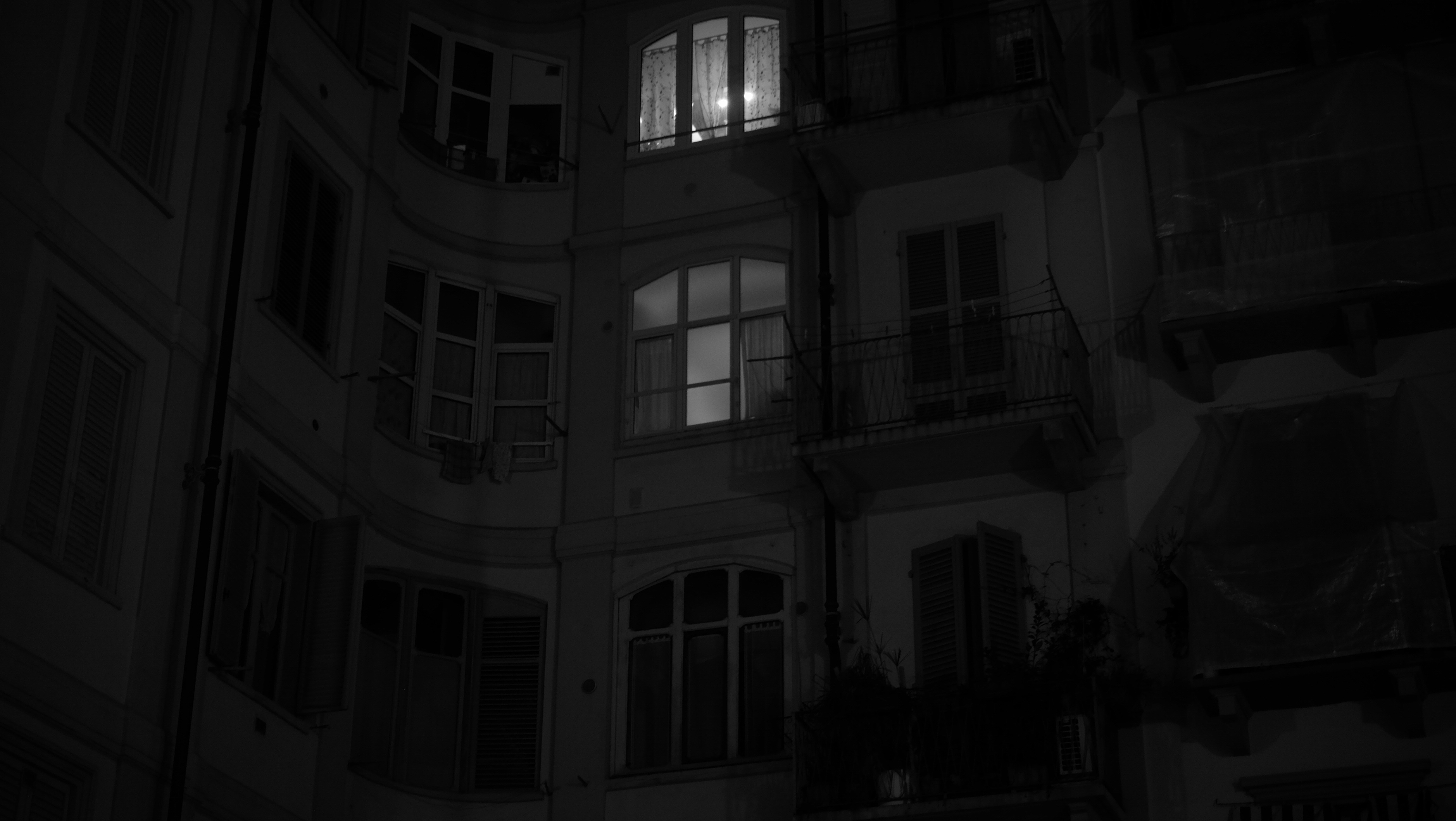 A tall building with windows lit up at night