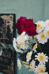 A vase filled with white and red flowers