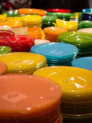 A table topped with lots of colorful plates