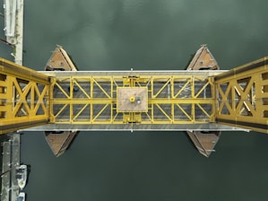 A yellow bridge over a body of water