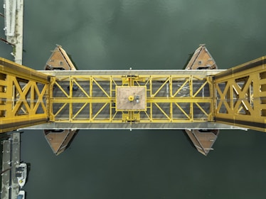 A yellow bridge over a body of water