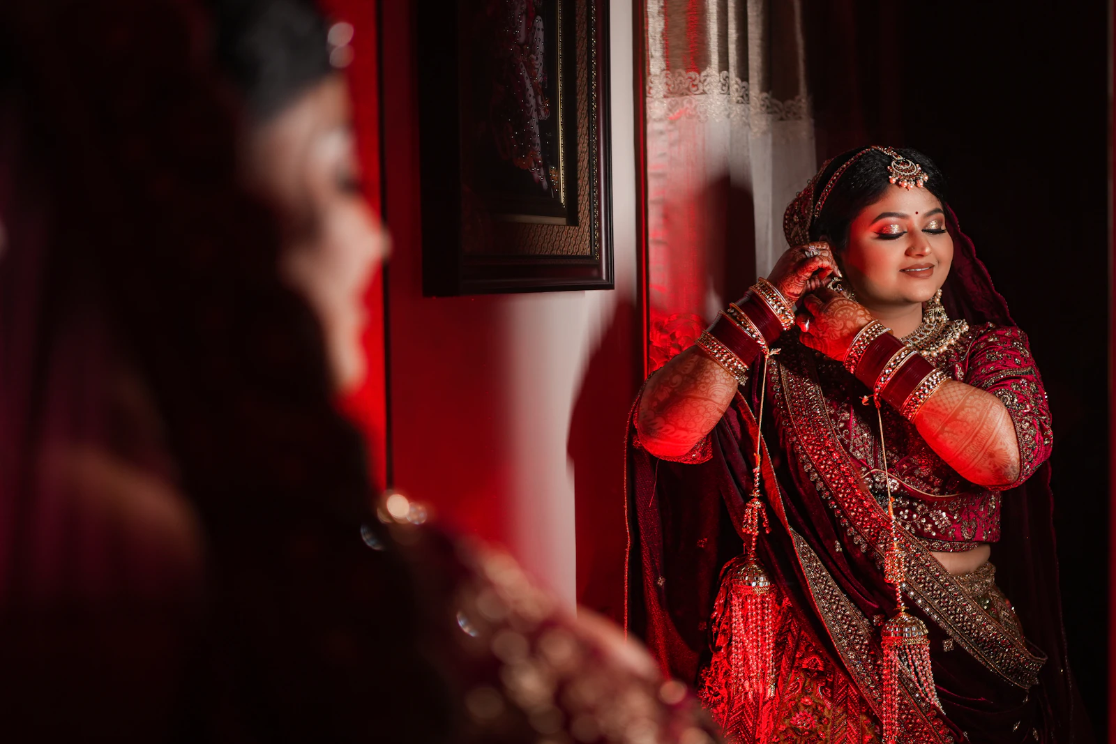 A bride standing before a mirror while getting ready