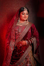 A woman in a red and gold wedding outfit