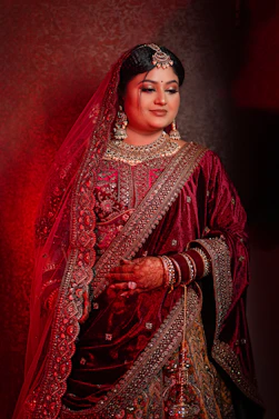A woman in a red and gold wedding outfit