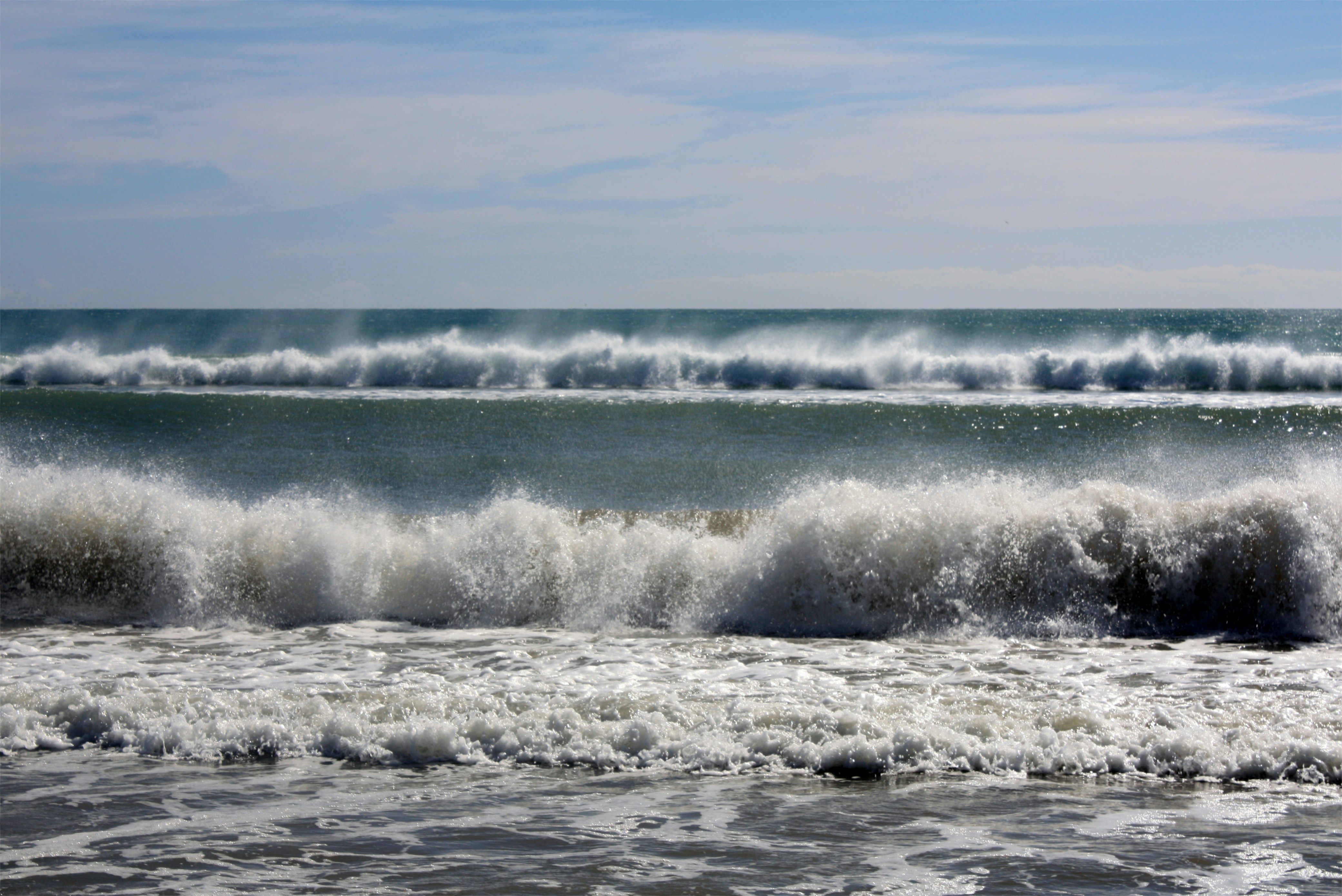 A person riding a surfboard on a wave in the ocean
