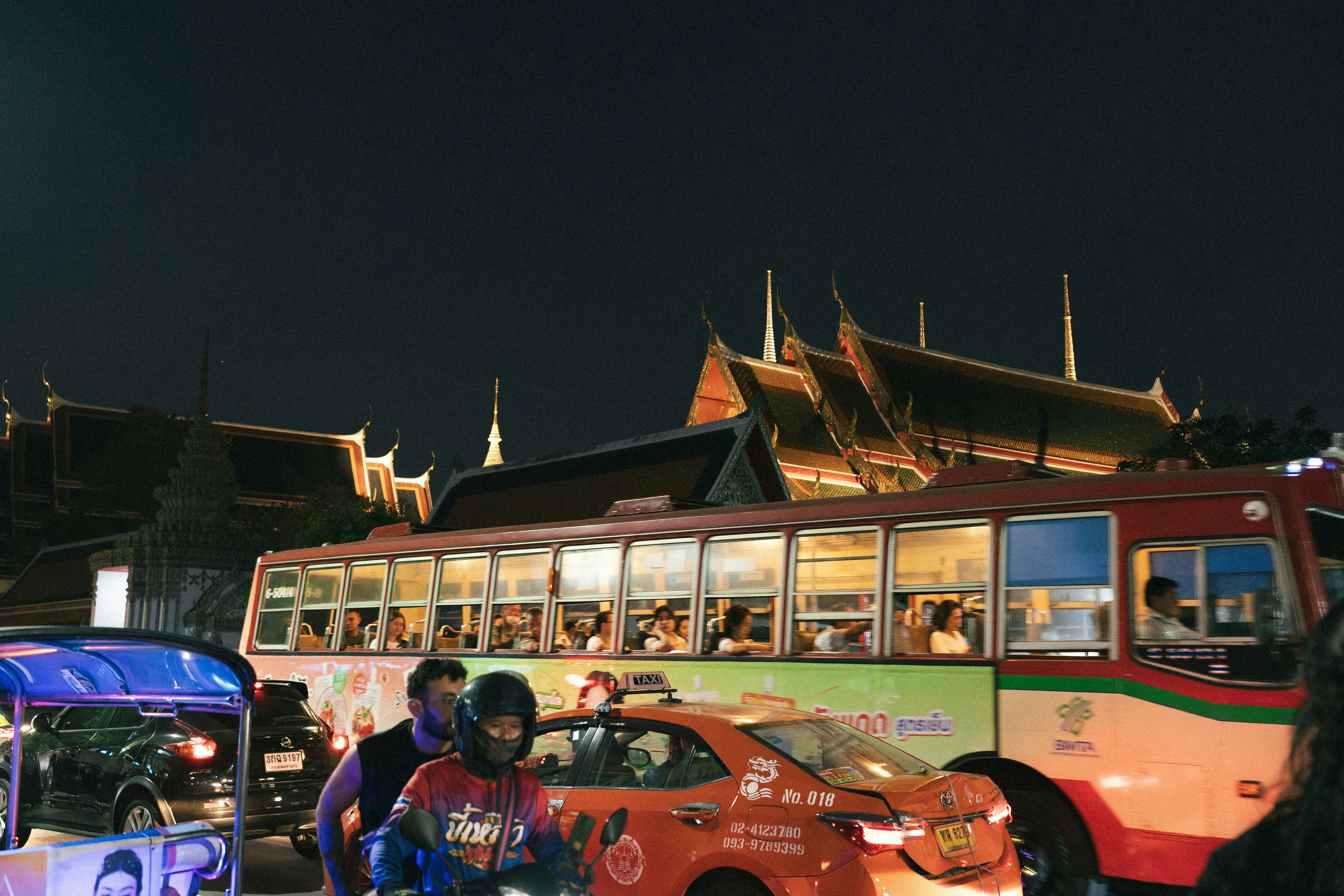 A group of people standing in front of a bus