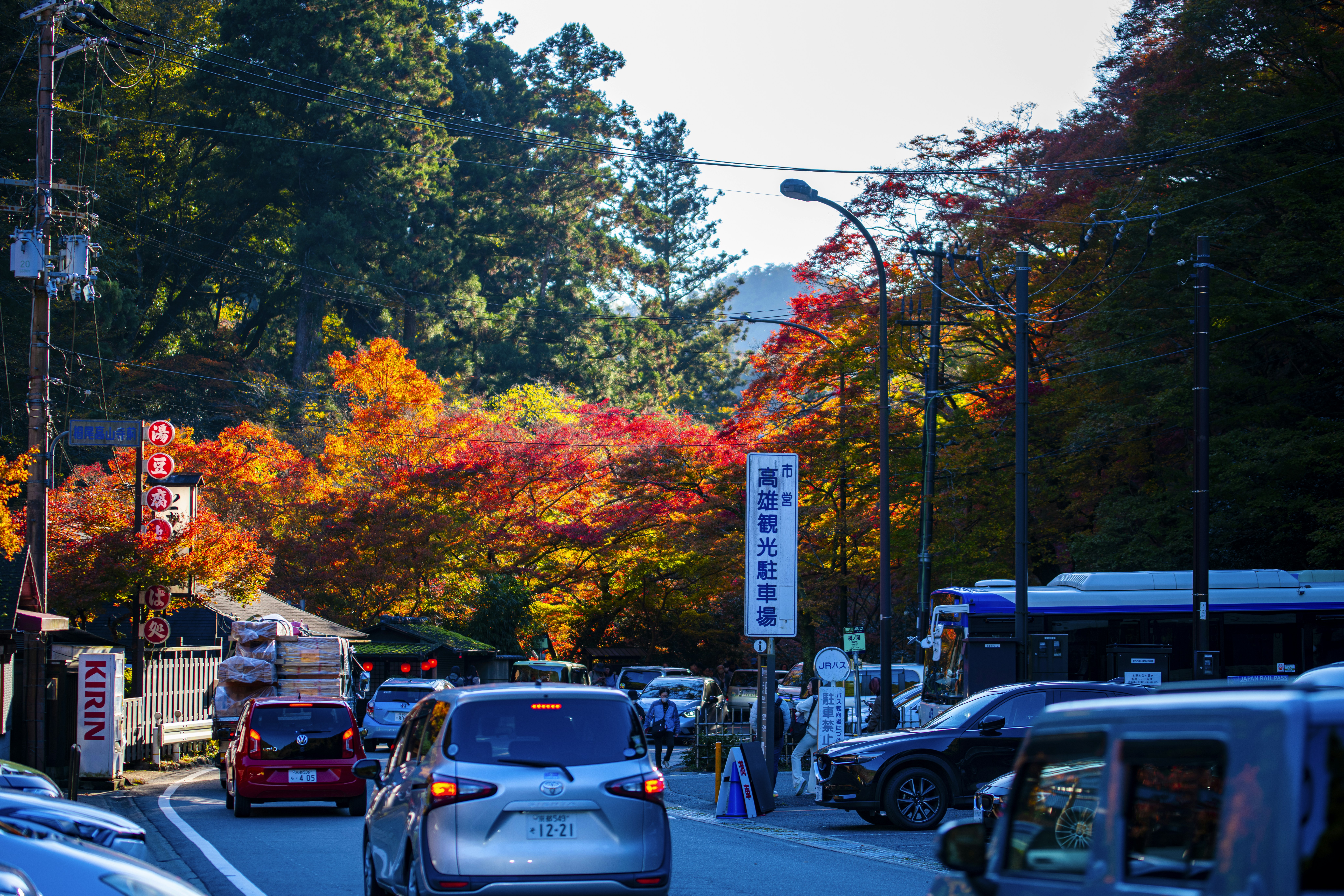 A street filled with lots of traffic next to trees