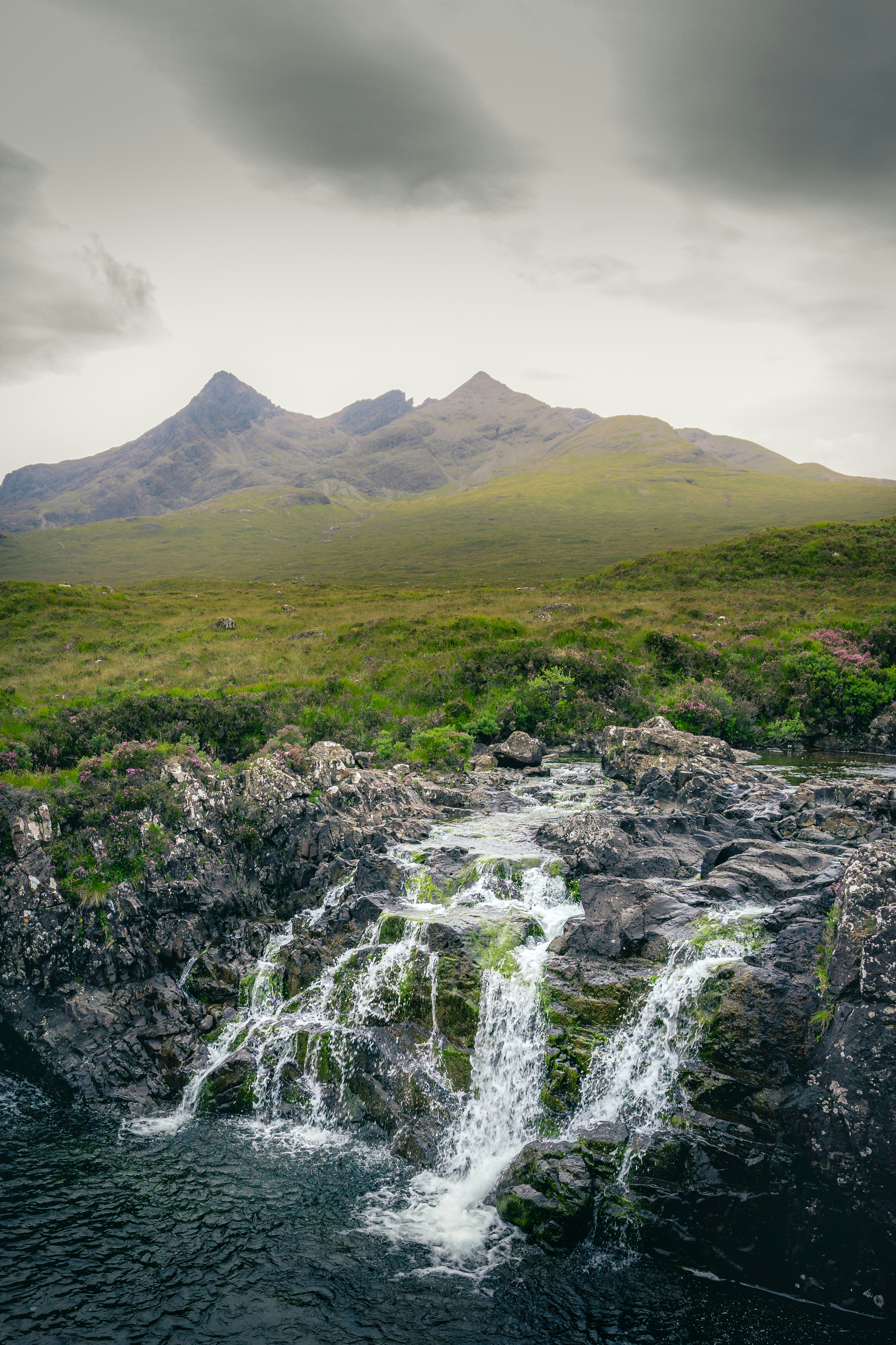 A waterfall in the middle of a green field