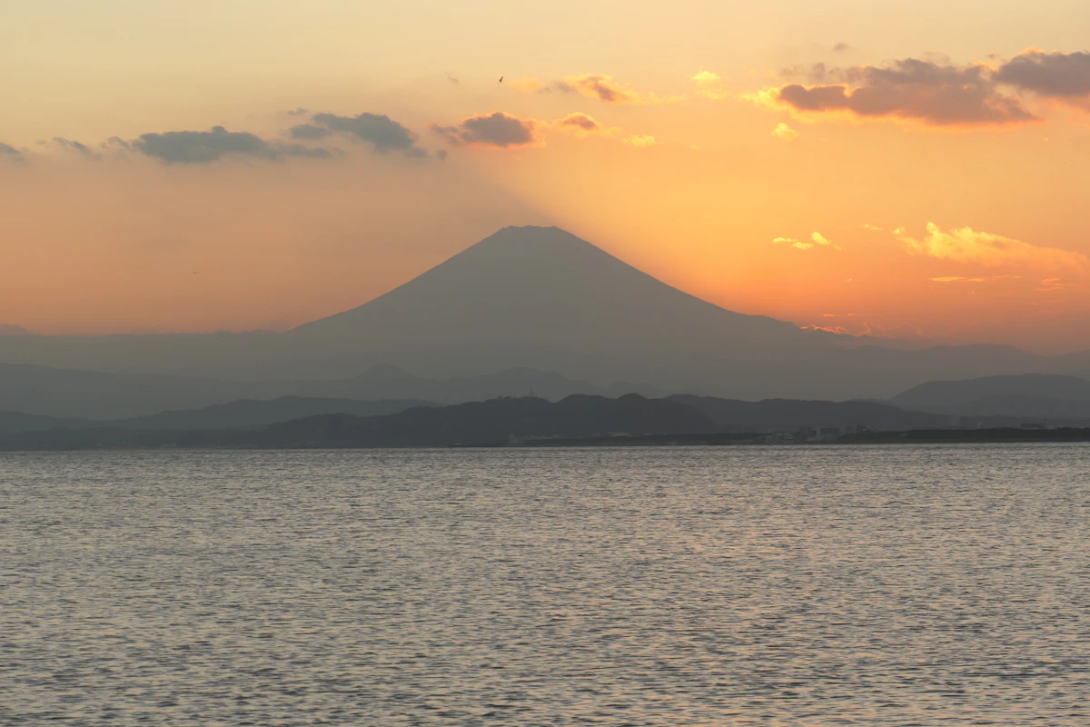Sunset over Mount Fuji visible across Sagami Bay from Yuigahama beach in Kamakura