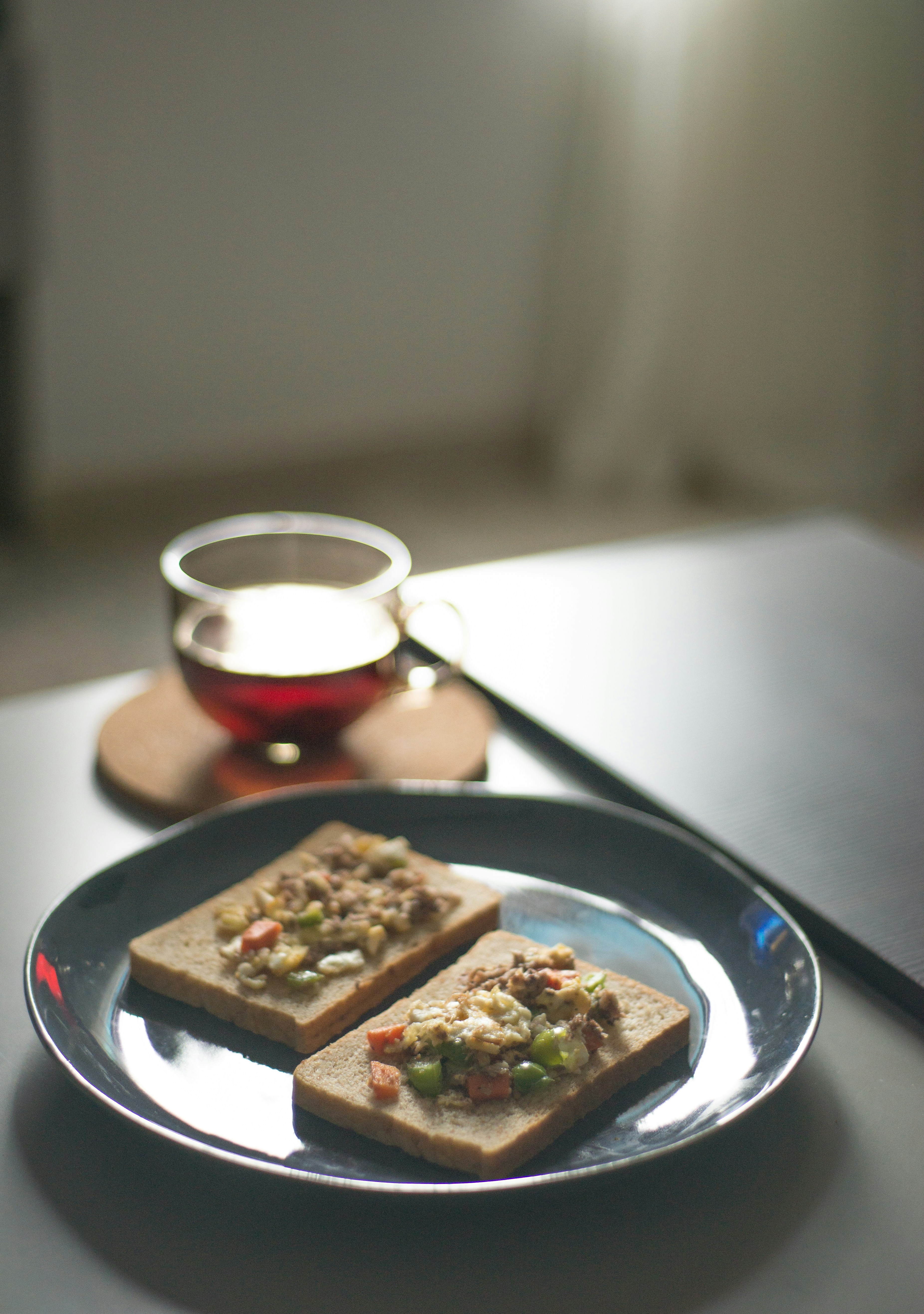 A plate of food on a table with a cup of tea