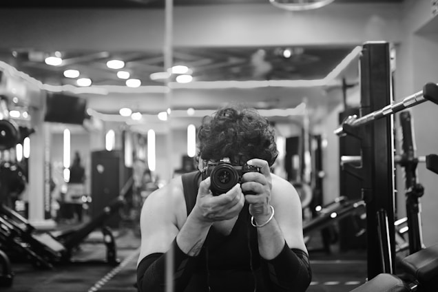 A woman taking a picture of herself in a gym