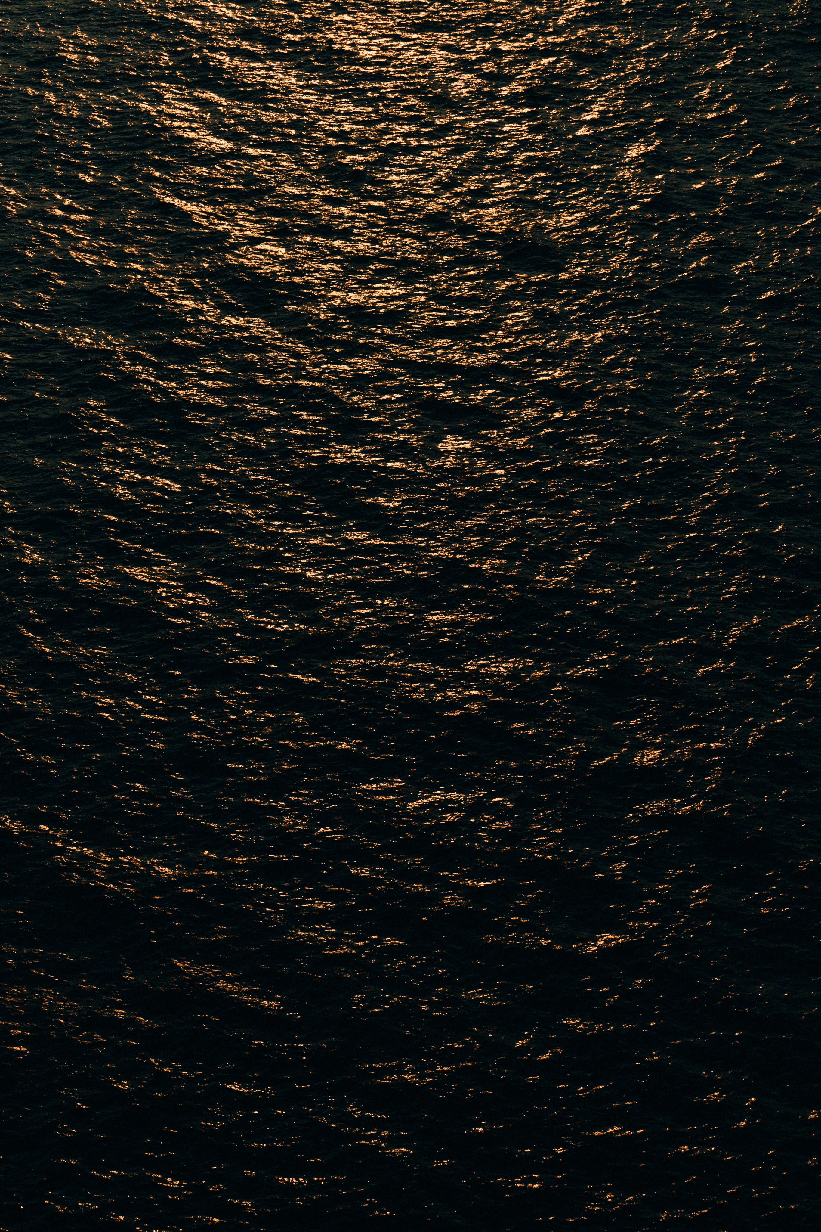 A boat floating on top of a large body of water