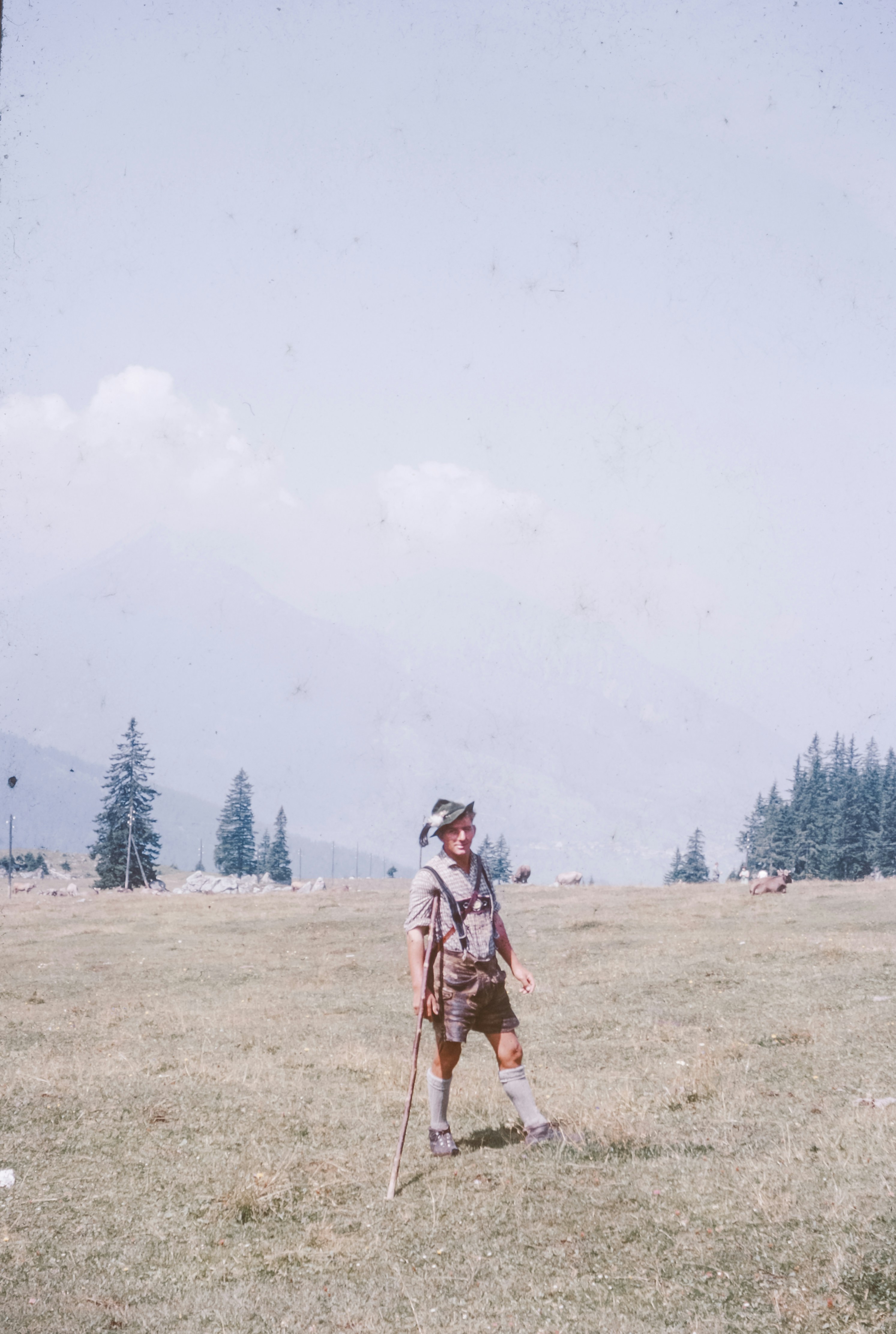 A man standing on top of a grass covered field