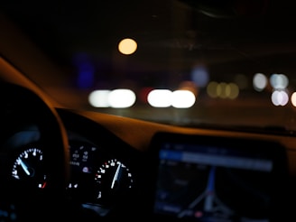 The dashboard of a car at night time