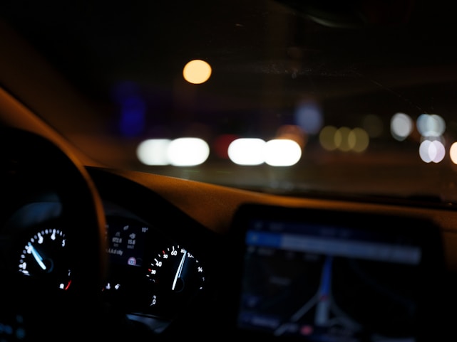 The dashboard of a car at night time