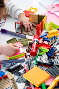 A child playing with legos on a table