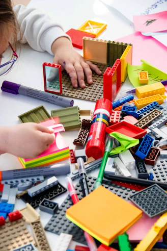 A child playing with legos on a table