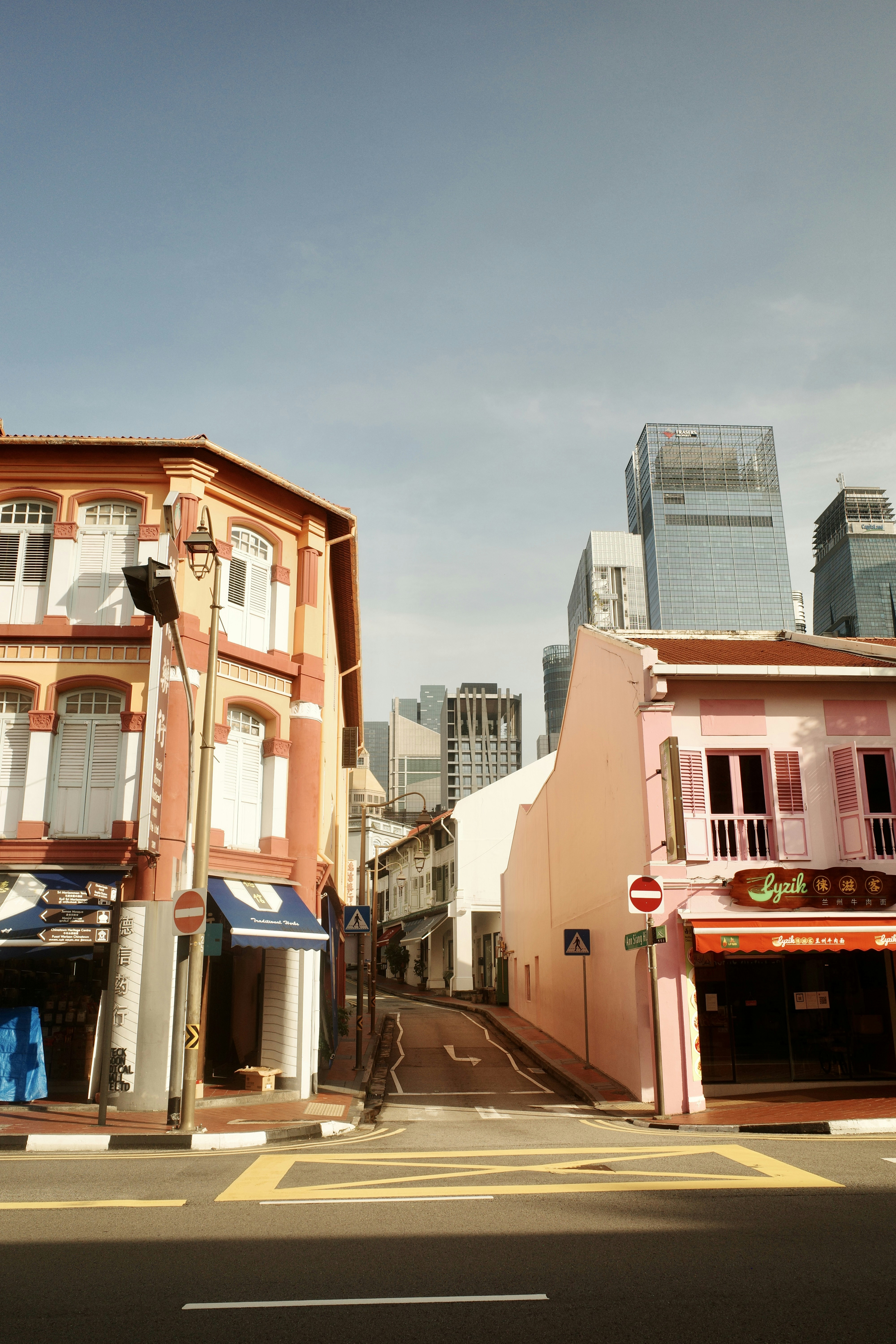 A city street with a few buildings on both sides of the street