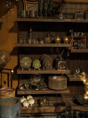 A room filled with lots of wooden shelves filled with dishes