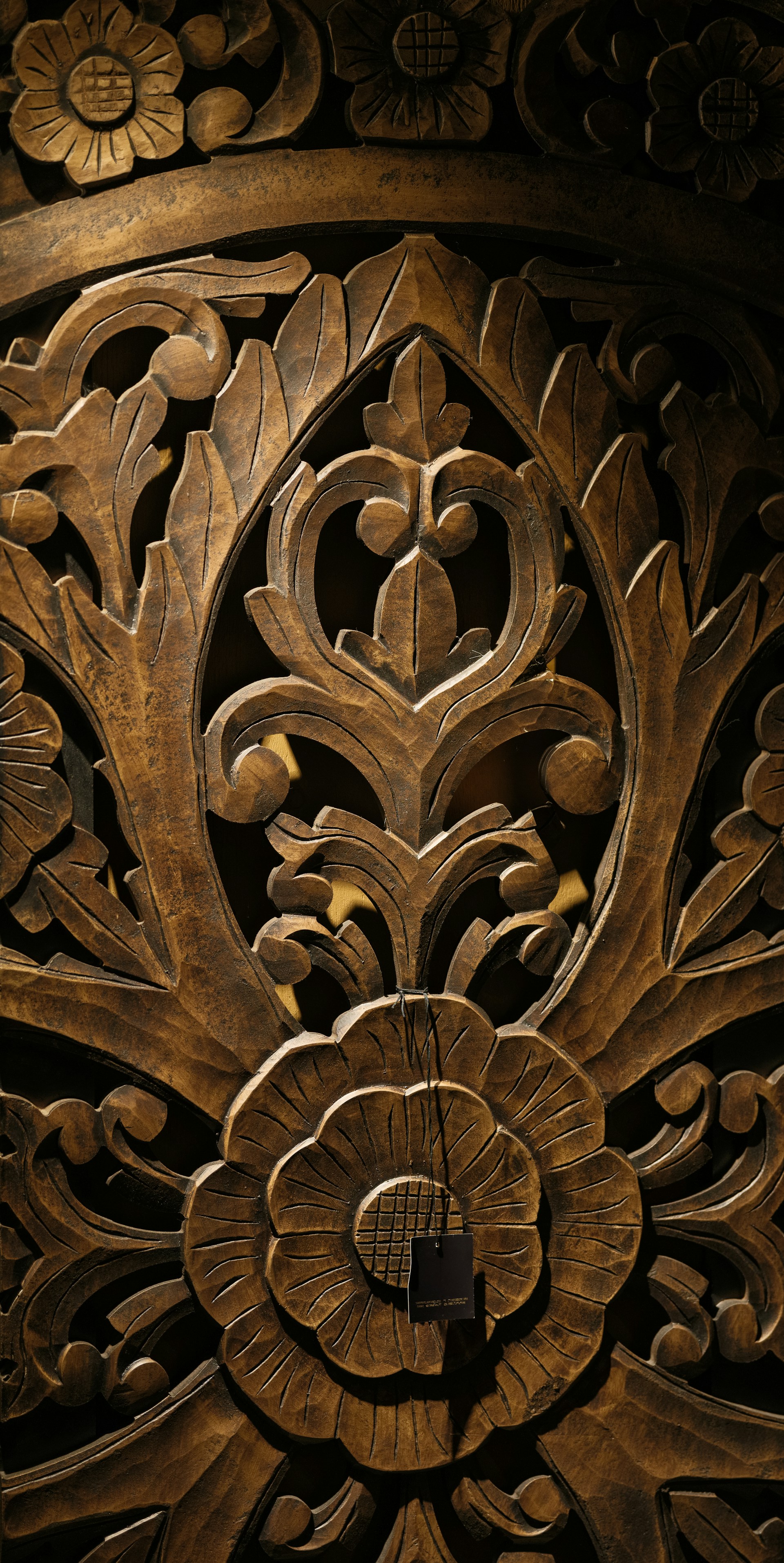 A close up of a wooden carving on a wall