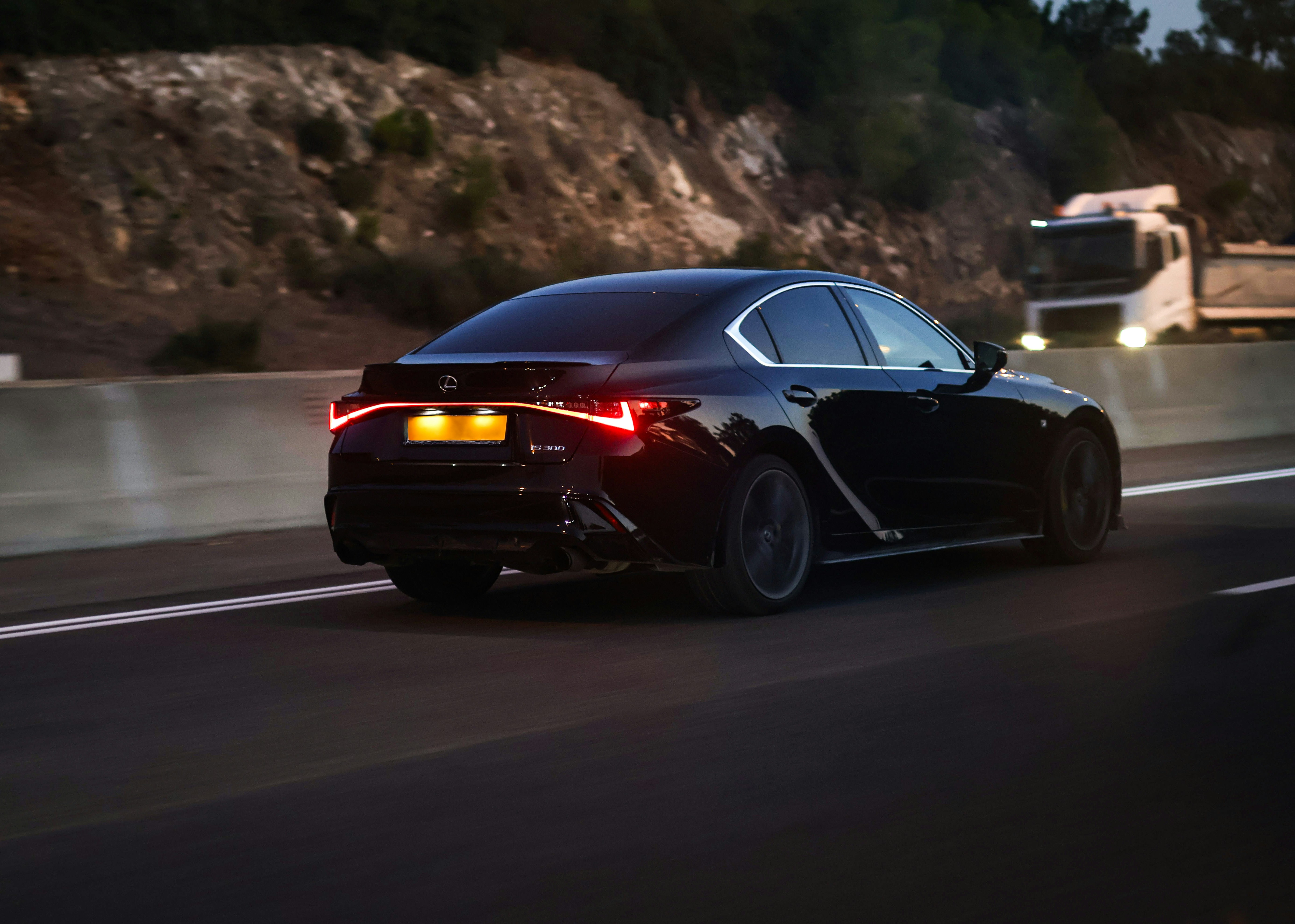 A black car driving down a highway at night photo – Free Black car ...