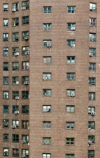 A tall brick building with lots of windows