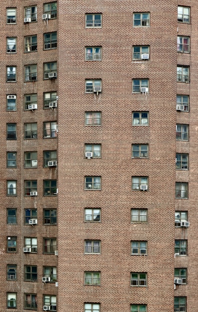 A tall brick building with lots of windows