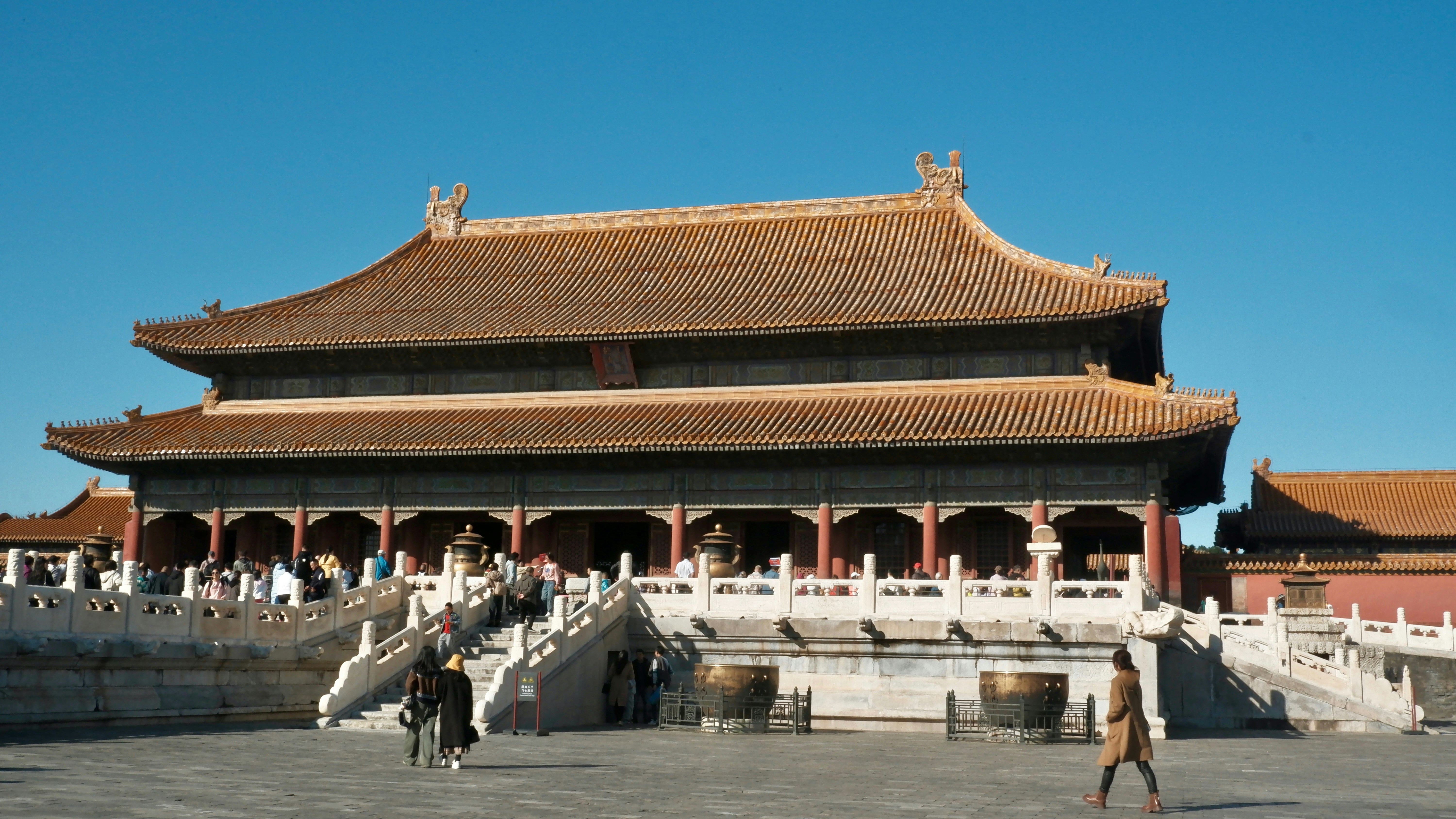 A person walking in front of a building