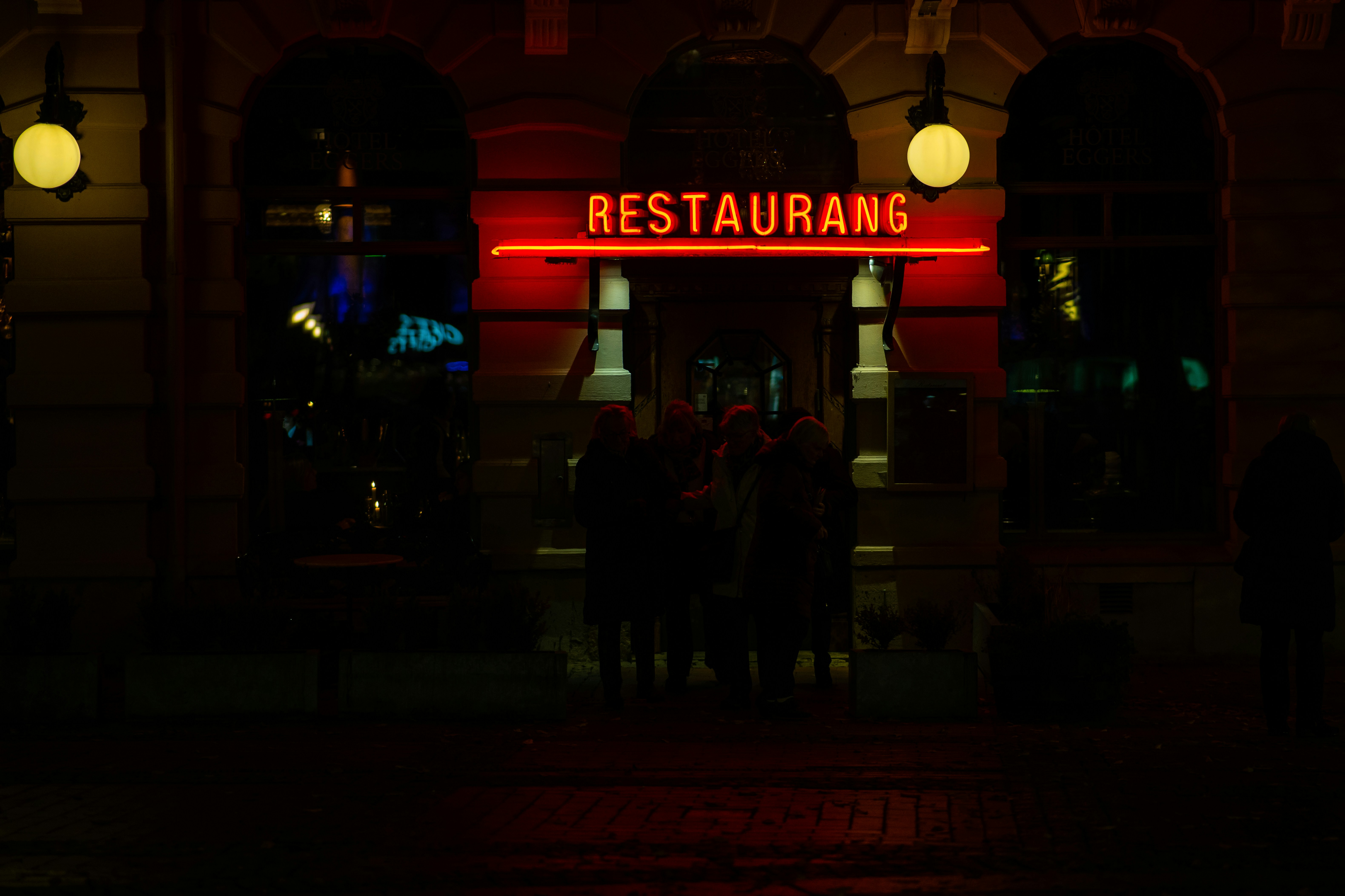 A restaurant sign lit up in the dark