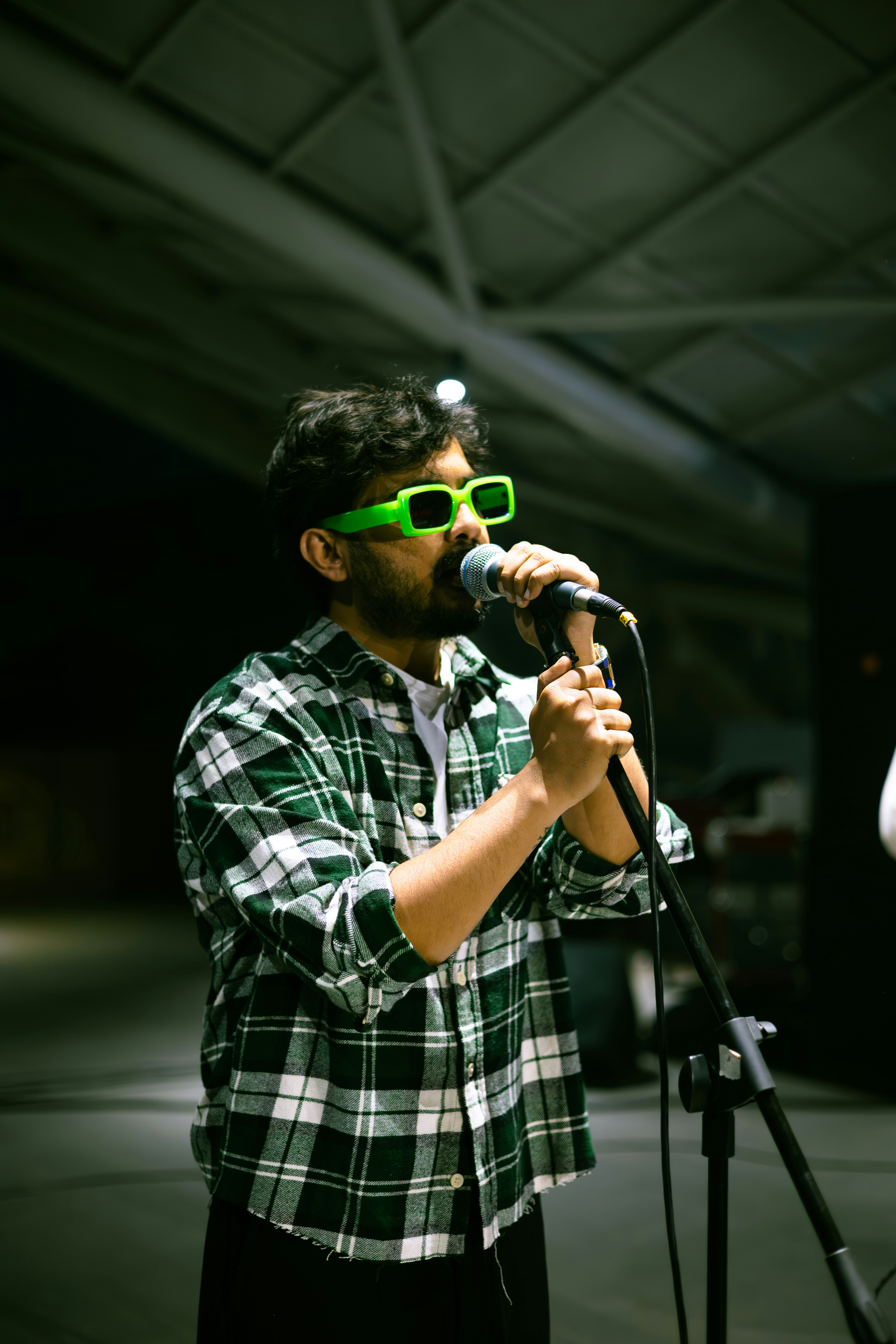 A man with sunglasses on singing into a microphone photo – Free ...