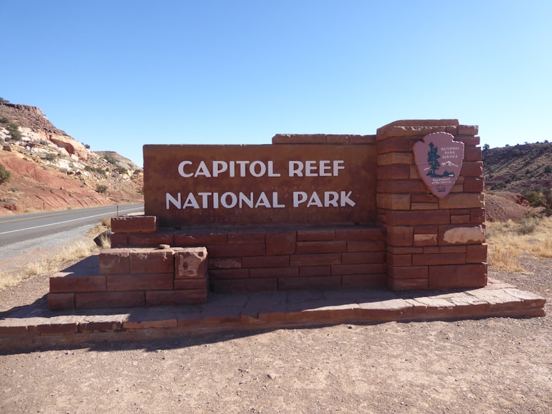 A sign for capitol reef national park on the side of a road
