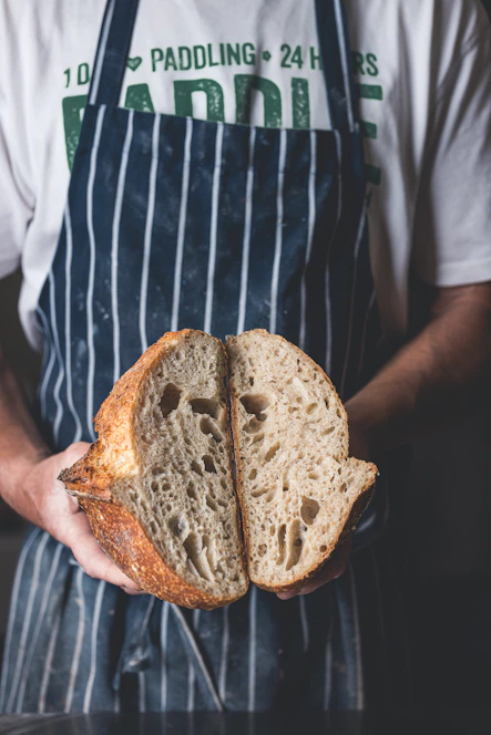 A man holding a loaf of bread in his hands