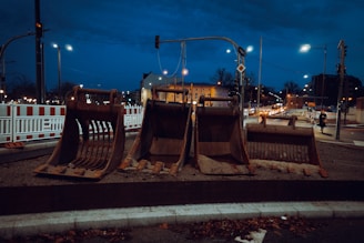 A couple of wooden chairs sitting on top of a sidewalk
