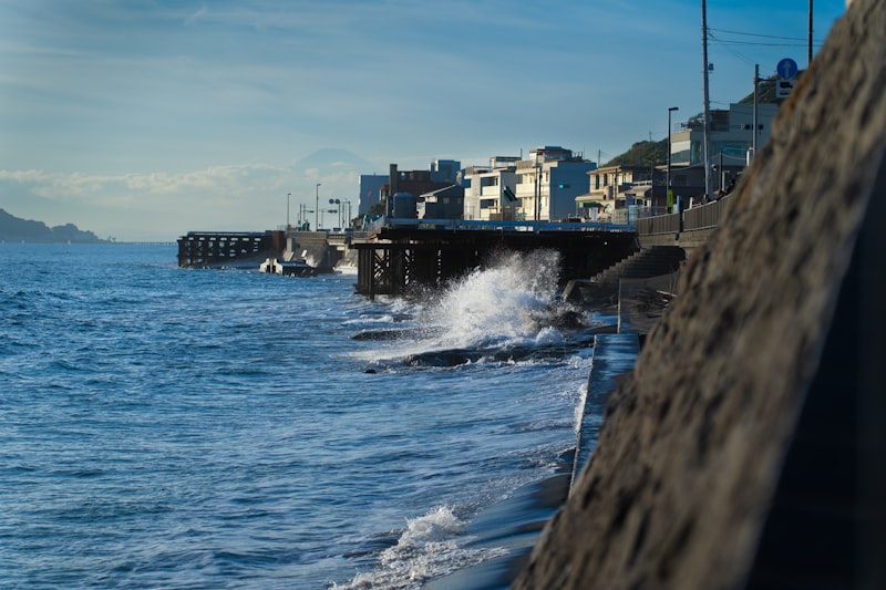 A body of water with buildings along the Japanese coastline