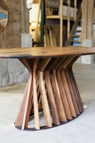 A table made out of wooden sticks and a clock